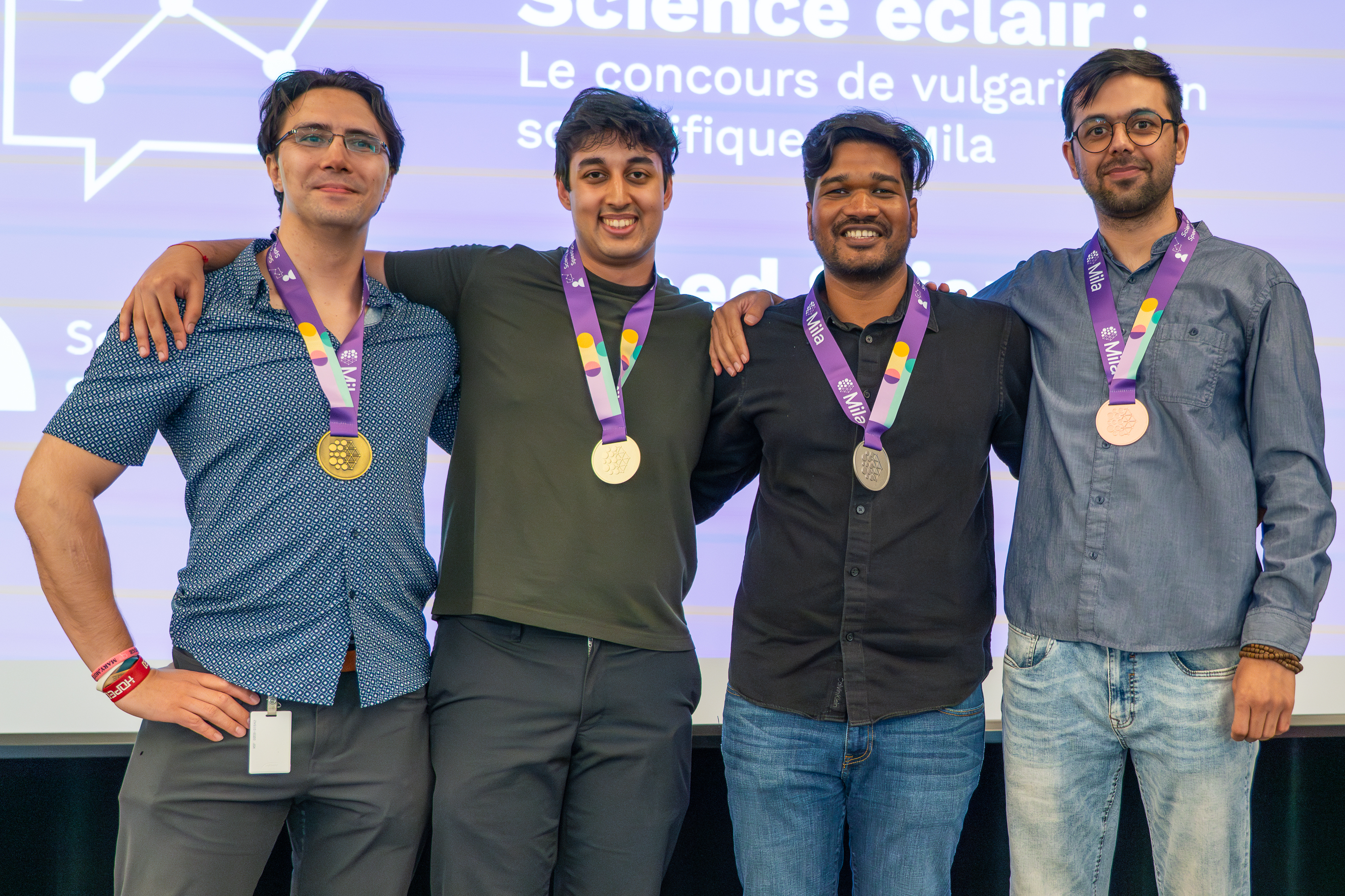 Group picture of the 4 winners of Mila's scientific communication contest