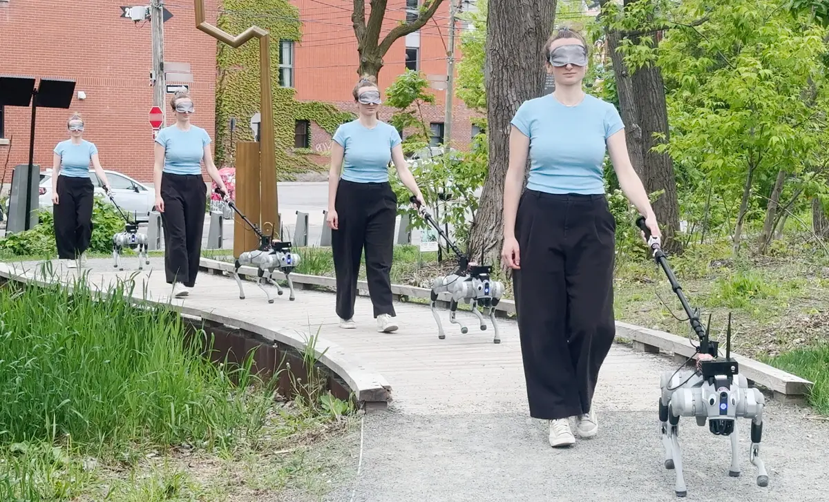 A women walking a robot dog outside
