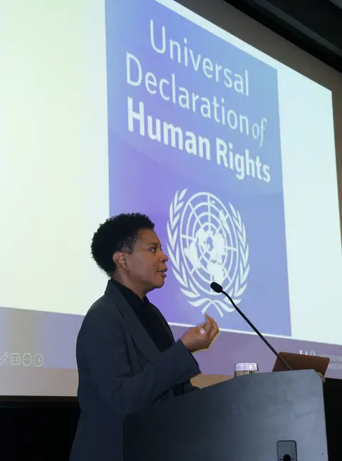 A woman delivering a speech to an audience.