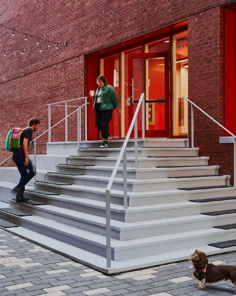 Mila members enter and exit the office building.