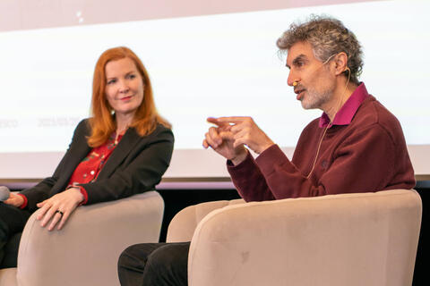 Picture of Kate Crawford and Yoshua Bengio discussing AI's future