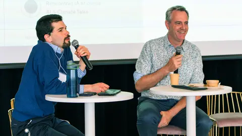 David Rolnick and Maxime Larrivée speaking at a panel discussion. 