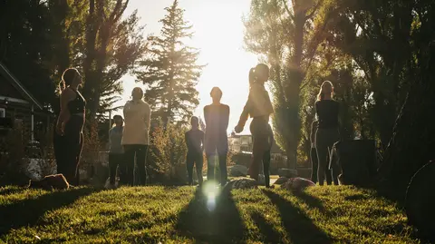 Group of people standing in a sunny park. 