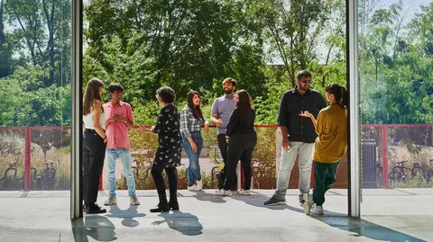 Students from Mila chat outdoors.