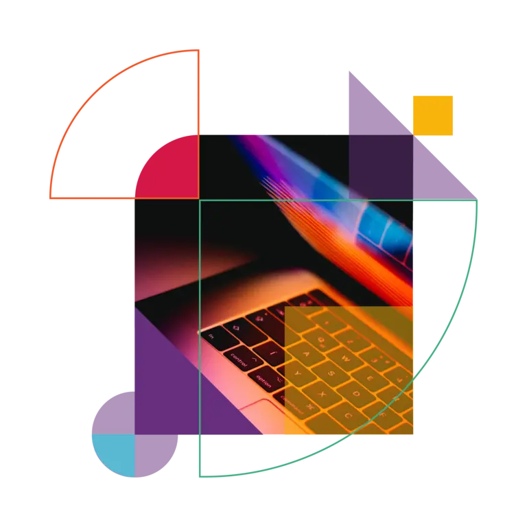 Half-open laptop, switched on in a dark room.