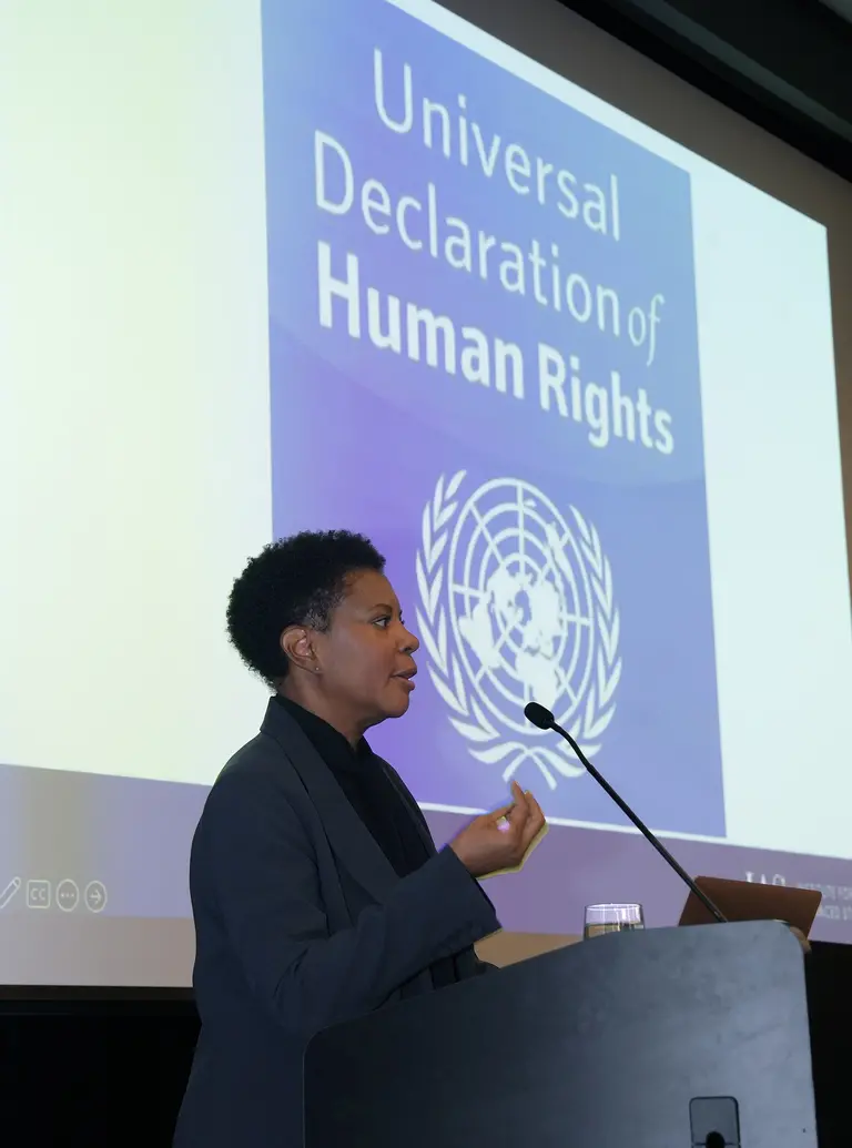 A woman delivering a speech to an audience.