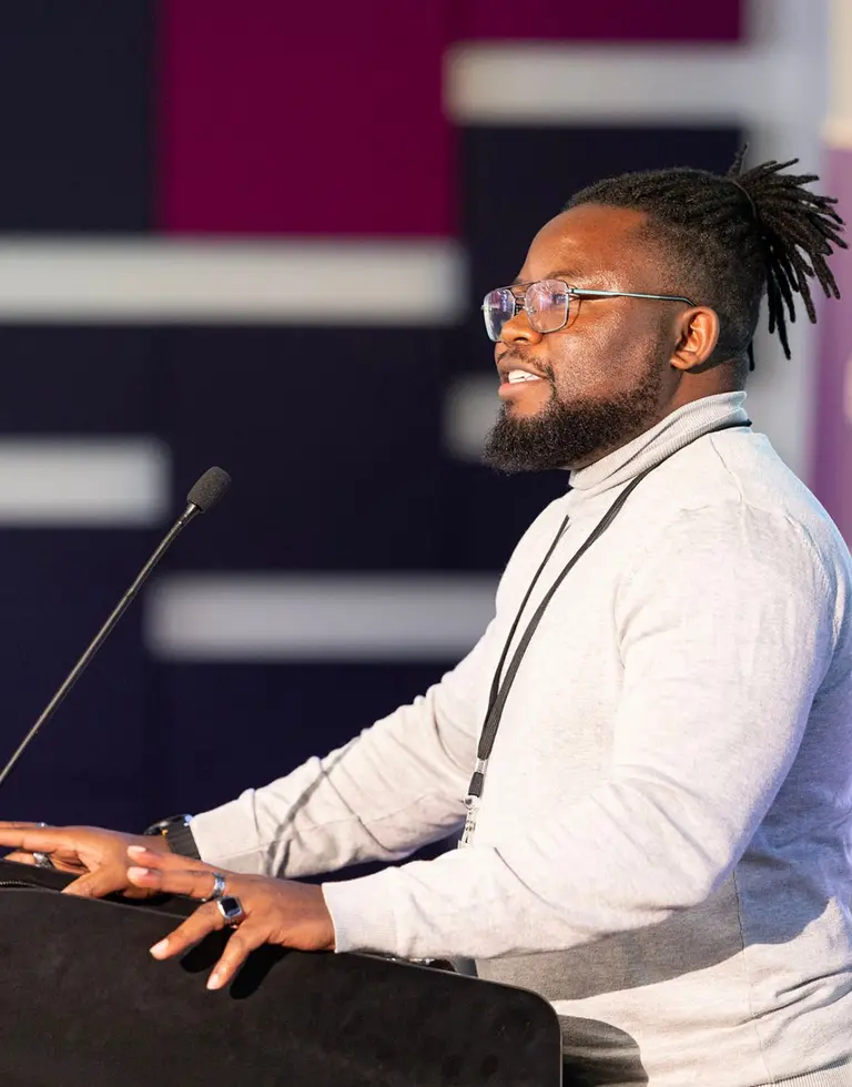 Picture of Adio presenting her projects facing an audience