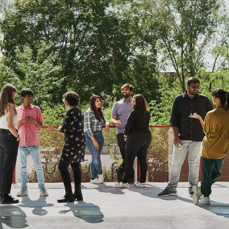 Mila students and professors chatting outside.