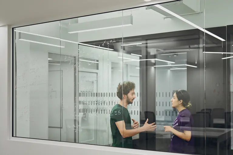 two students talking in a lab
