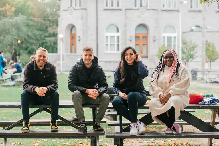 picture of Maket's team sitting outside in front of a building