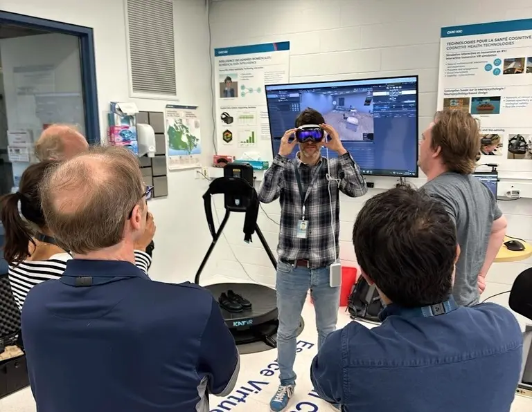 A group of researchers at the National Research Council in Brossard tests out SilicoLabs' platform, LABO, and the Apple Vision Pro.