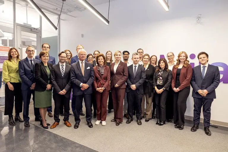 Picture of Sweden Delegation in front of Mila Logo