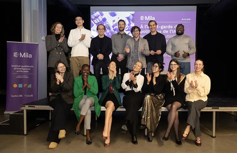 Group picture of participants of Mila AI Policy Fellowship sitting on stage