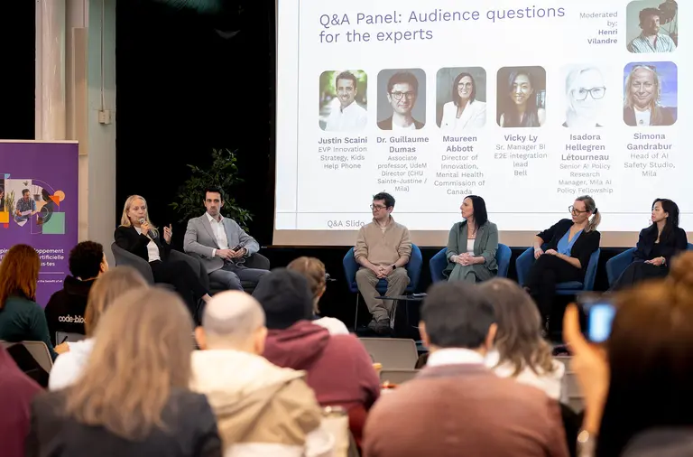 Picture of Simona Gandrabur with a panel of experts during Bell Mila Hackathon