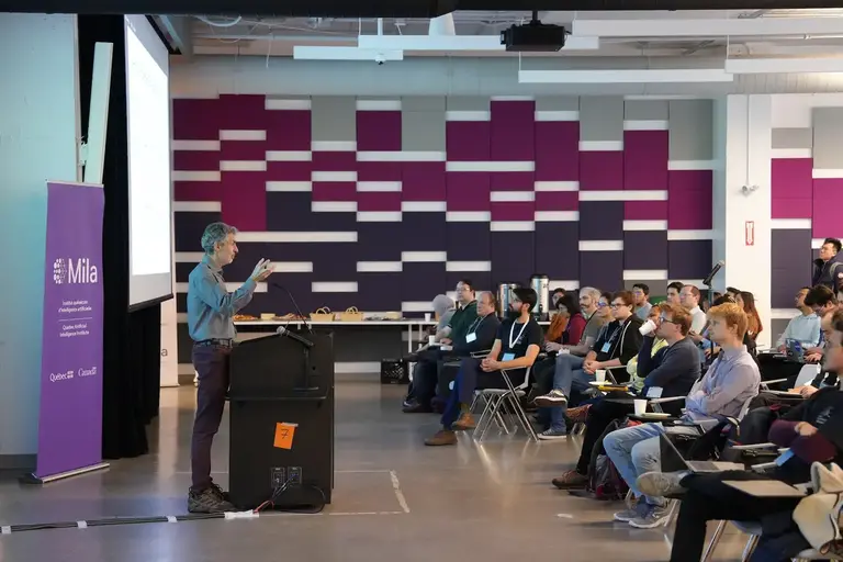 Yoshua Bengio giving a talk at a workshop. 