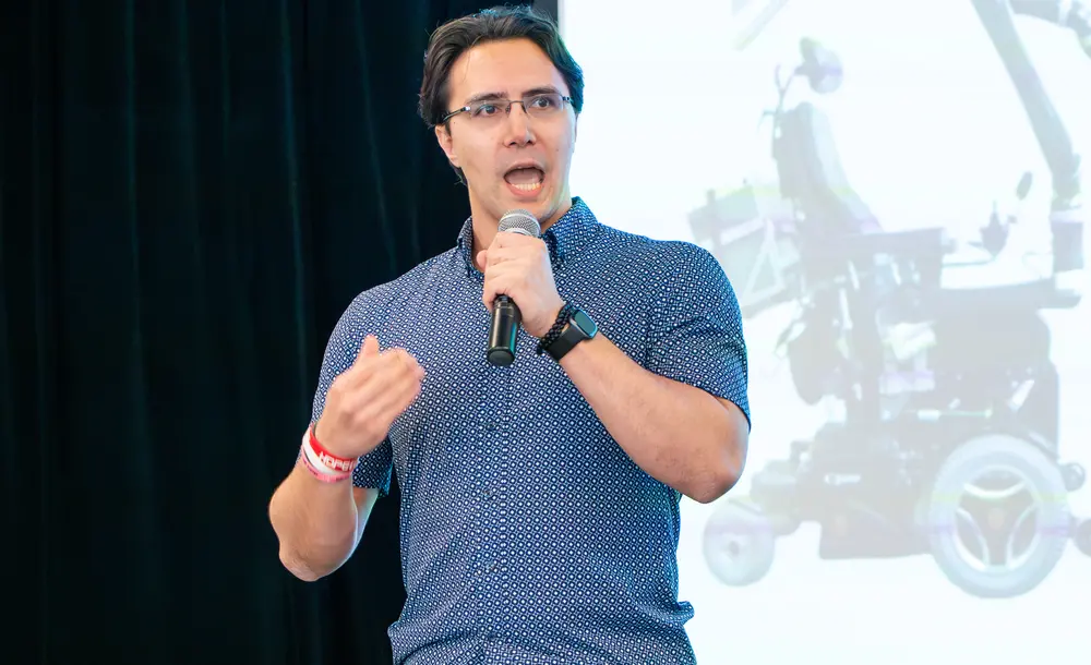 Picture of Michael Przystupa presenting his work in front of an audience during speed science contest