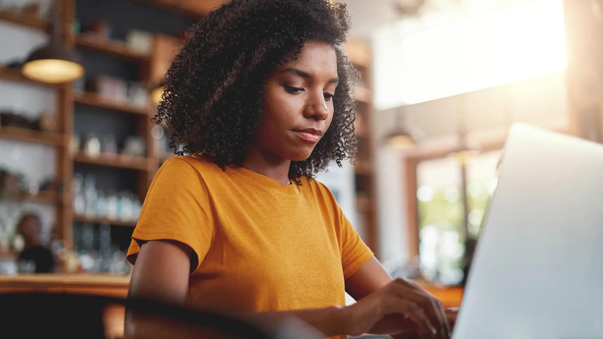 A black woman working on a computer. 