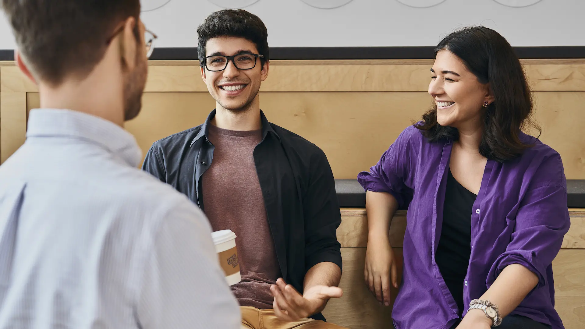 Students laugh in the lounge of the Mila premises.