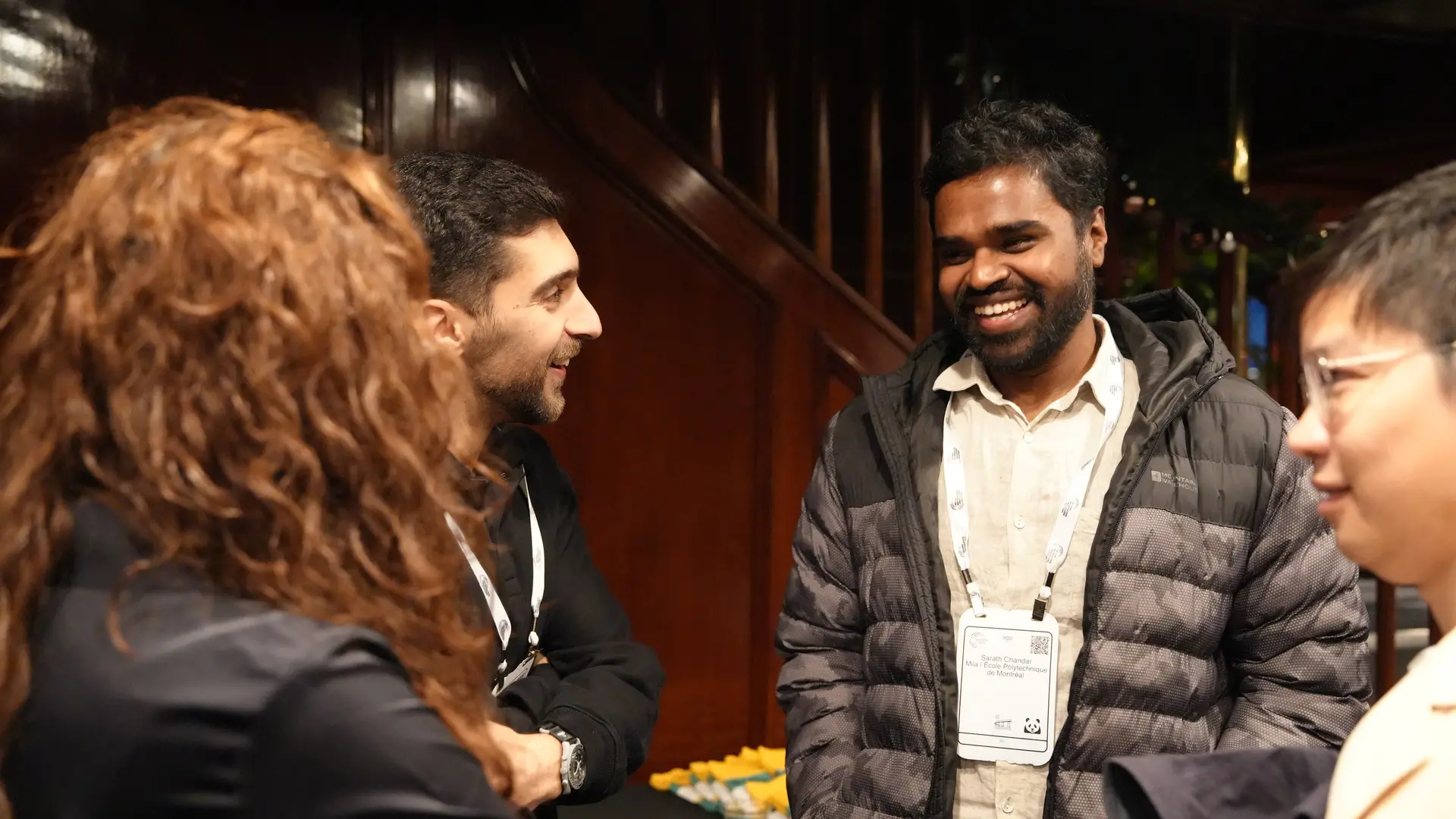 Picture of a group of professors and staff from mila chatting
