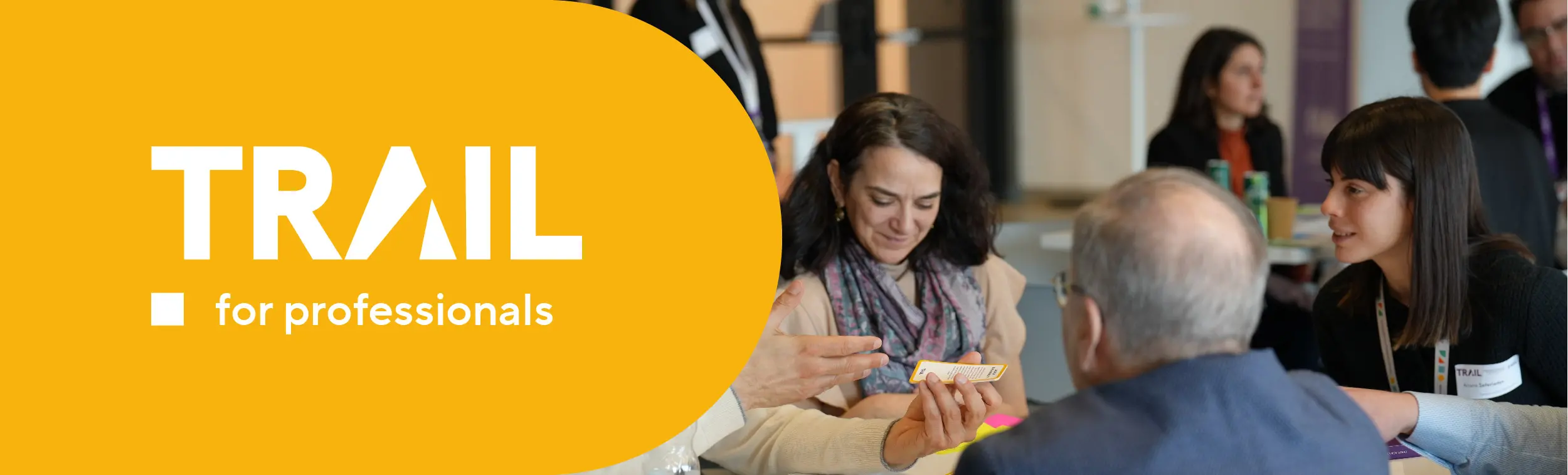 Logo of the program and photo of three people working together. 