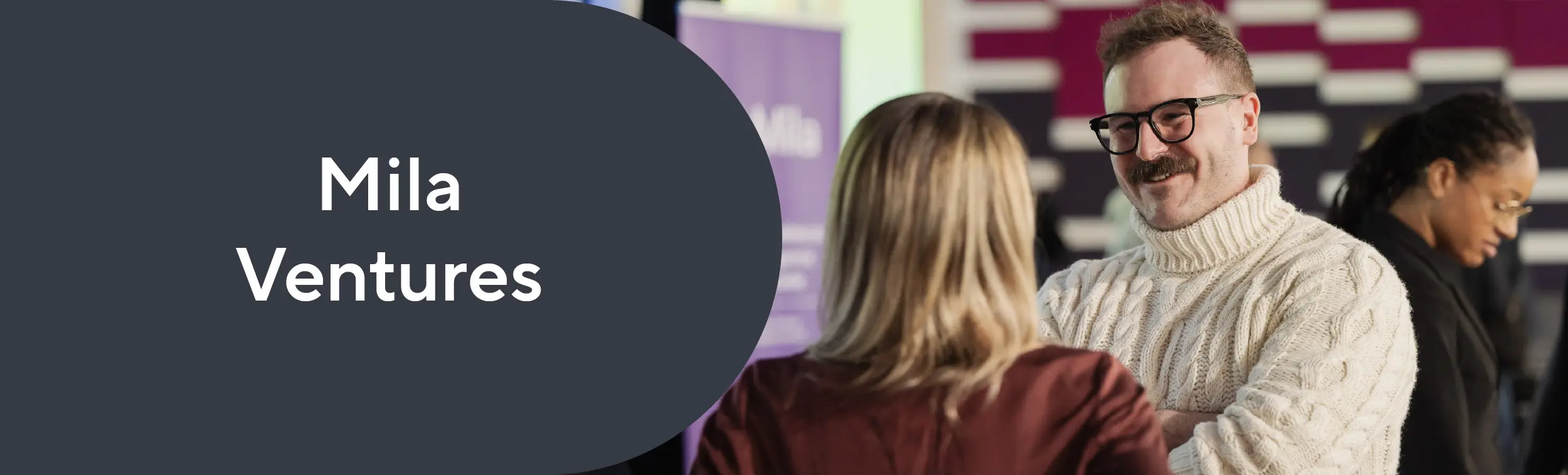 A man and a woman talking together at an event.