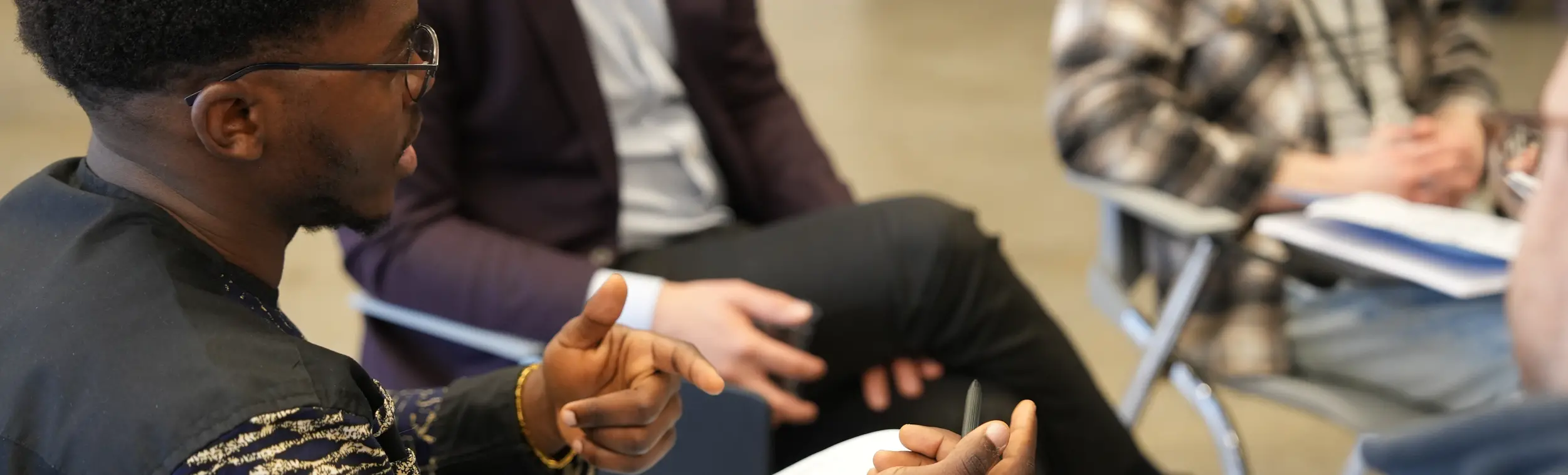 a young man asking question on a round table activity