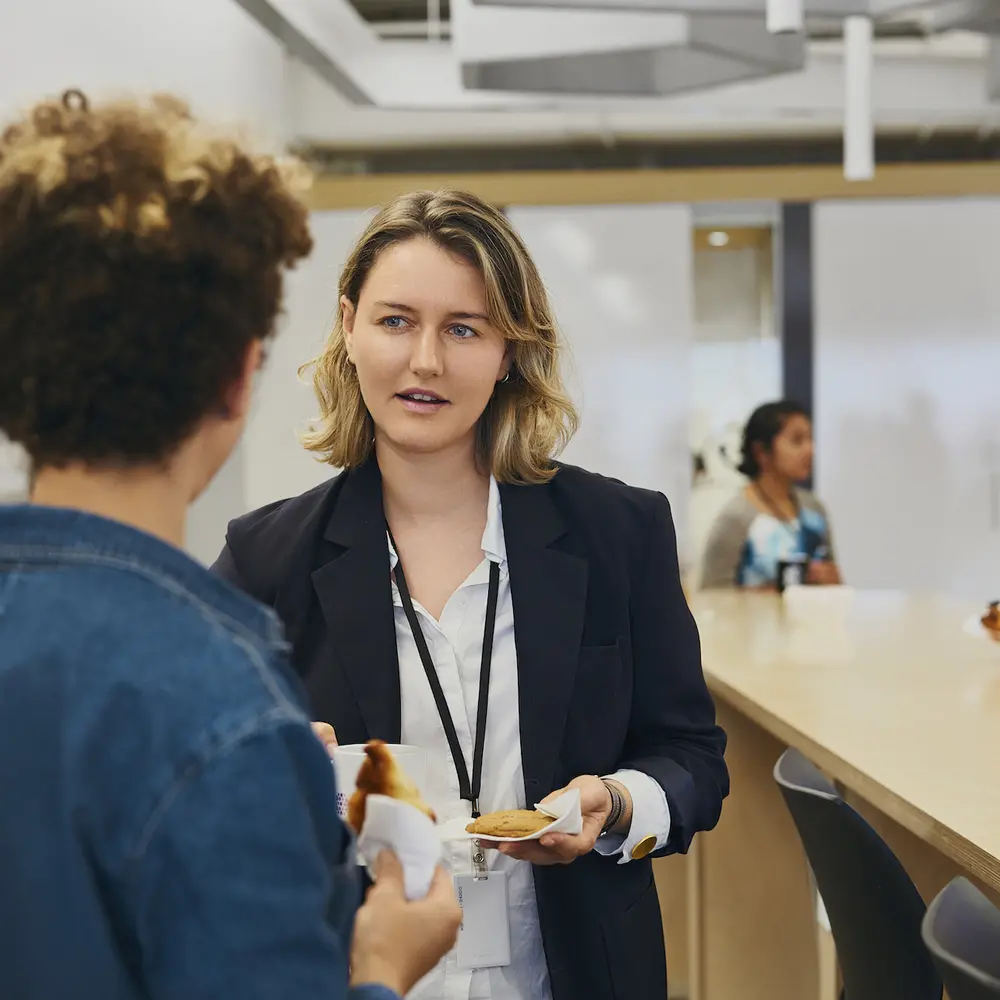 Two Mila employees discussing in a common area.