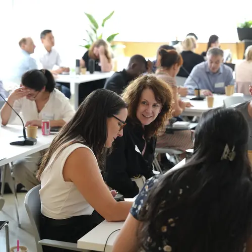 A group of people talking at a workshop. 