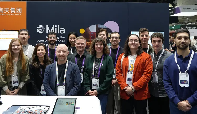 Picture of Mila delegation in front of Mila Booth at NeurIPS 2025