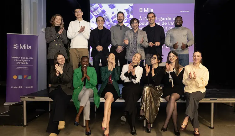 Group picture of participants of Mila AI Policy Fellowship sitting on stage