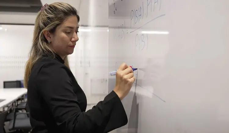 Picture of Prof. Samira A. Rahimi writing on a white board