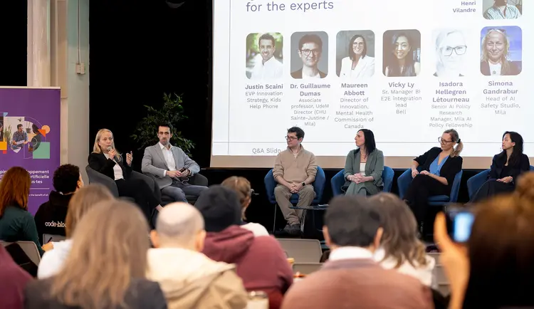 Picture of Simona Gandrabur with a panel of experts during Bell Mila Hackathon
