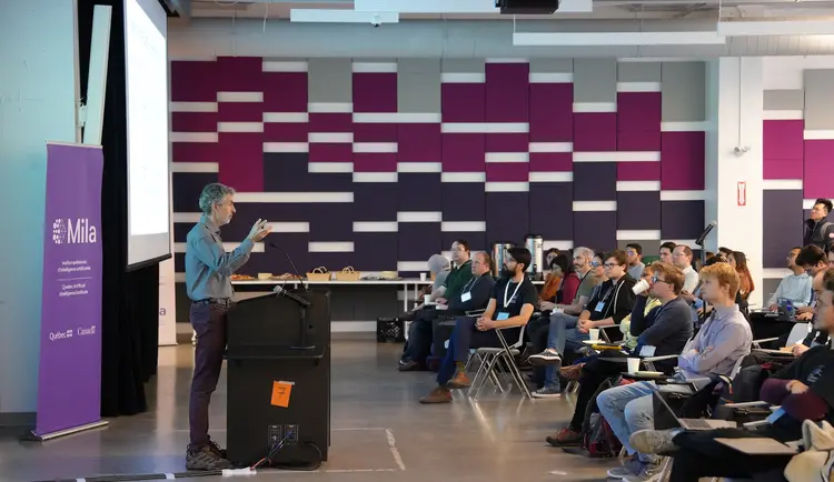 Yoshua Bengio giving a speech in front of the participants of the GFlowNet Workshop