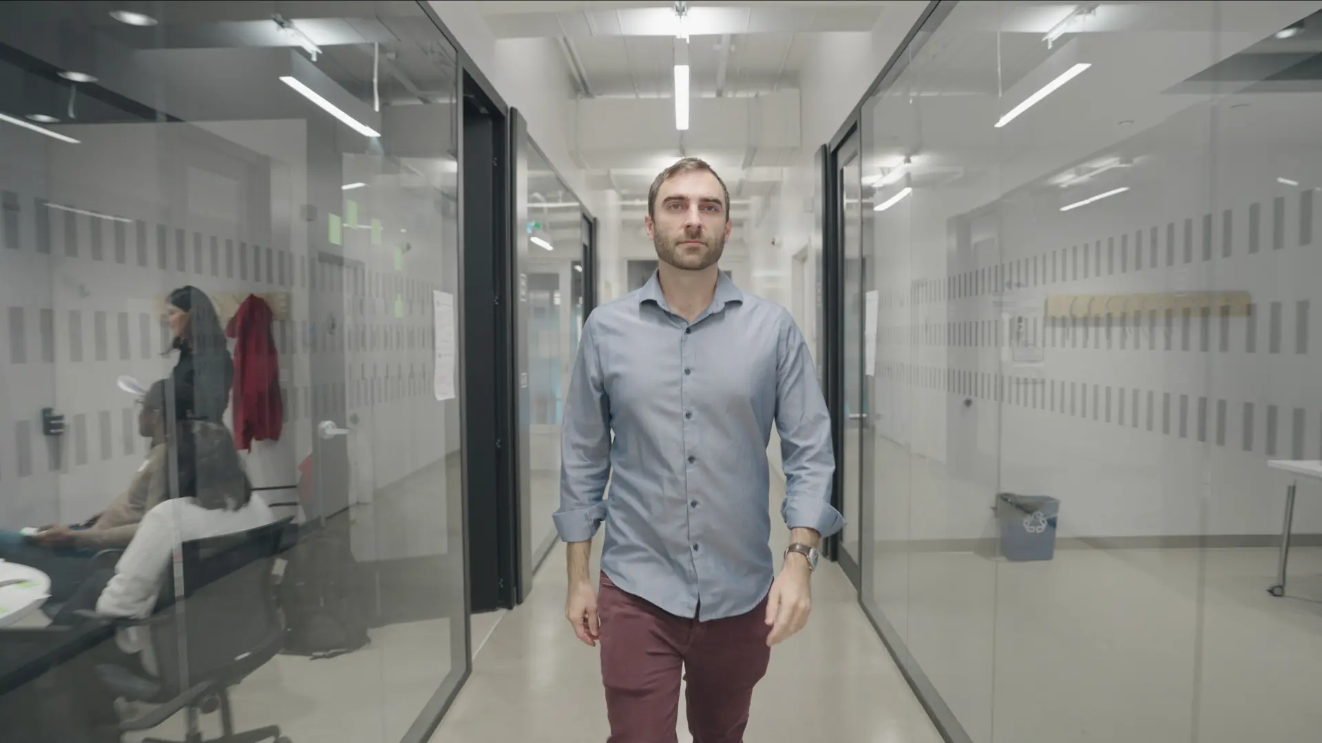 Glen Berseth walks down a corridor at Mila. 